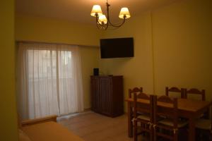 a dining room with a table and a television on the wall at DTO en Mar del Plata para 6 o 4 Personas in Mar del Plata