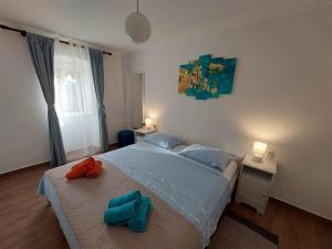 a bedroom with a large bed with two towels on it at House Antonio in Miholascica (66-1) in Miholašćica