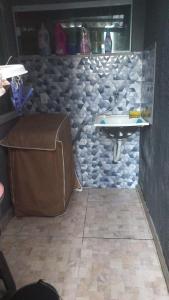 a bathroom with a stone wall and a sink at casa da paz in Porto Seguro