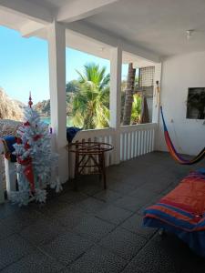 a room with a christmas tree on a porch at HakunaMatata in Puerto Ángel