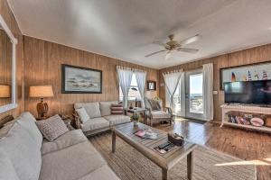 a living room with a couch and a table at Fernandina Cottage Deck, Direct Beach Access in Fernandina Beach