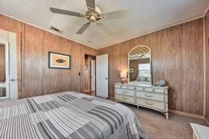 a bedroom with a bed and a dresser and a mirror at Fernandina Cottage Deck, Direct Beach Access in Fernandina Beach