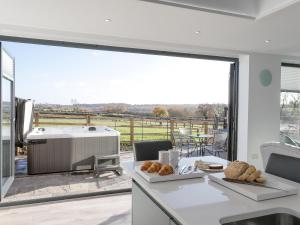 a kitchen with a view of a tub and a patio at The Retreat - Ukc3845 in Ticknall