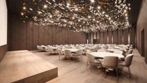 a dining room with tables and chairs and a chandelier at SOHO Hotel Auckland in Auckland