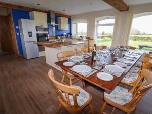 a kitchen and dining room with a table and chairs at The Oaks in Ellesmere