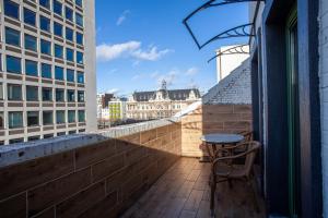 a balcony with a table and chairs on a building at ATW Apartments in Antwerp