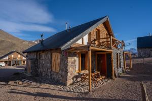 a small stone house with a metal roof at Los Molles Complejo Turistico in Los Molles +31 photos