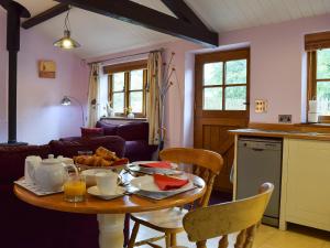 a kitchen with a table with food on it at The Old Stables in Swerford