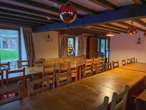 a dining room with a large wooden table and chairs at Duvale Barn in Bampton