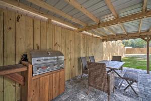 a patio with a grill and a table and chairs at Apopka Getaway with Yard and Covered Patio in Apopka