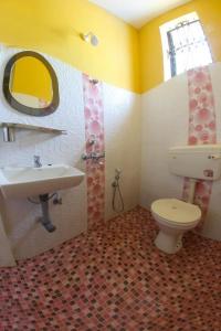 a bathroom with a toilet and a sink at Regina Residency Inn in Palolem