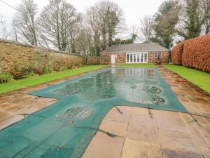 a swimming pool in the yard of a house at Barn Cottage in Saint Erth
