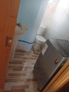 a small bathroom with a toilet and a sink at Departamentos semiamoblado Puerto Montt in Puerto Montt