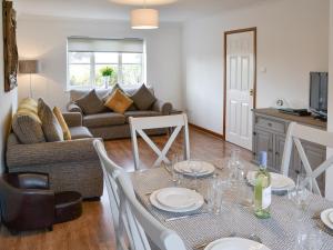 a living room with a table and a couch at The Chase in Walcott