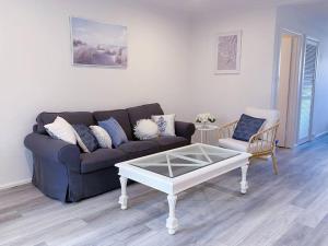 a living room with a couch and a coffee table at Newly renovated! Minutes away from Mother's Beach and Main Street! in Mornington