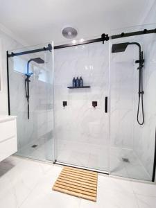 a shower with a glass door in a bathroom at Newly renovated! Minutes away from Mother's Beach and Main Street! in Mornington