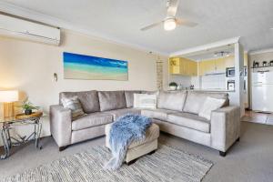a living room with a couch and a table at Ocean Breeze at Palm Beach in Gold Coast