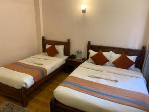 Letto o letti in una camera di Hotel Ramanam