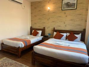 Letto o letti in una camera di Hotel Ramanam