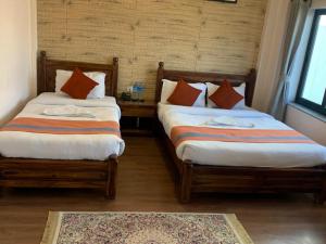 Letto o letti in una camera di Hotel Ramanam