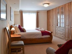 a bedroom with a large bed and a window at Sunsets Spinnaker in Newquay