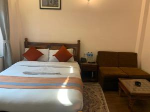 Letto o letti in una camera di Hotel Ramanam