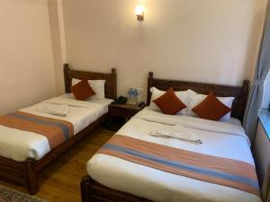 Letto o letti in una camera di Hotel Ramanam