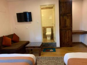 Letto o letti in una camera di Hotel Ramanam