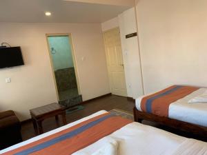 Letto o letti in una camera di Hotel Ramanam