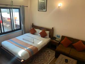 Letto o letti in una camera di Hotel Ramanam