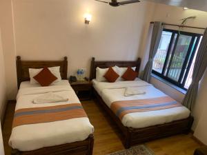 Letto o letti in una camera di Hotel Ramanam