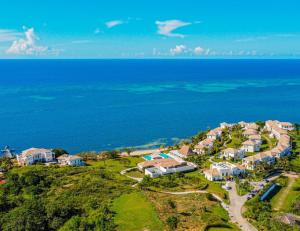 an aerial view of a house on a hill next to the ocean at Las Verandas Hotel & Villas in First Bight