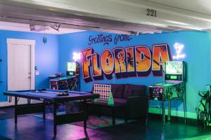 a gaming room with a ping pong table and arcade machines at Emerald-Gem-Inn • Laguna Haven/Beach Home! in Panama City Beach