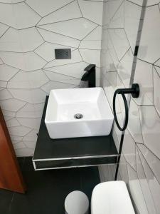 a bathroom with a sink and a toilet at Aurora Guest House - Luxury Apartment in Huaraz