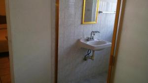 a bathroom with a sink and a mirror at DEPARTAMENTOS AMUEBLADOS CELIA in Morelia +19 photos