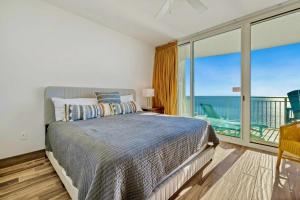 a bedroom with a bed and a view of the ocean at AQUA RESORT! Beachfront, 3 Bedroom Condo! 2 Bedrooms Beach Front! Sleeps 7! Free Beach Chairs by Dolce Vita Getaways PCB in Panama City Beach