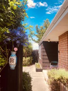 a vase on the side of a house at Family Villa in Christchurch