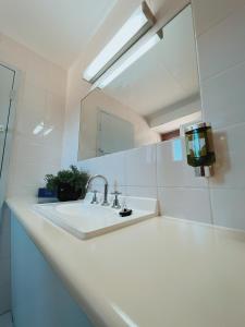 a white bathroom with a sink and a mirror at Moama Motel in Moama