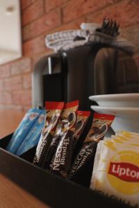 a black container filled with toothbrushes and food at Moama Motel in Moama