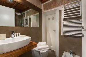 a bathroom with a sink and a toilet and a mirror at RomEnjoy Colosseo in Rome