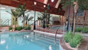 a large swimming pool in a building with a swimming pool at Spa Residence Carbona 101, 307 Apartman in Hévíz