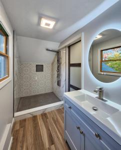 a bathroom with a sink and a shower at Le Elona, a private island getaway experience in Peabody