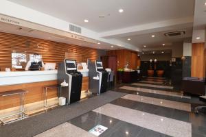 a lobby with two atm machines in a building at Silk Hotel in Iida