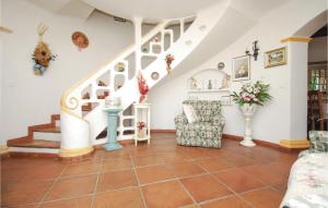 a living room with a staircase and a chair at Nice Home In Sainte Maxime With Wifi in Sainte-Maxime