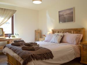 a bedroom with a bed with towels on it at Frith View in White Bridge