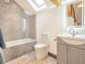 a bathroom with a toilet and a sink and a shower at The Granary in Inglewhite