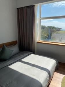 A bed or beds in a room at Kenting Little House