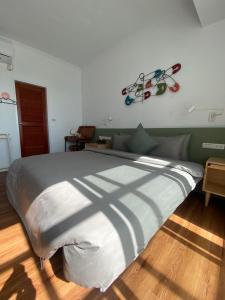a bedroom with a large bed with at Kenting Little House in Kenting