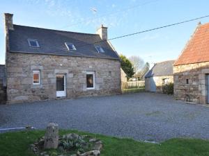 a stone house with a driveway in front of it at Maison bretonne rénovée, grand jardin, WIFI, à 5 min des plages et commerces - FR-1-368-4 in Trébeurden