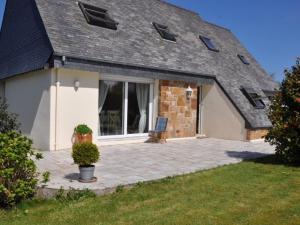 a house with a patio in front of it at Maison Louannec, 5 pièces, 8 personnes - FR-1-368-65 in Louannec